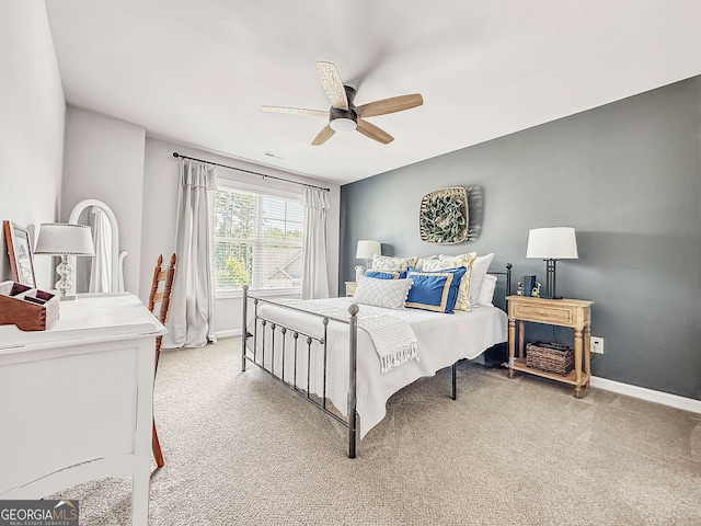 bedroom with ceiling fan and light carpet