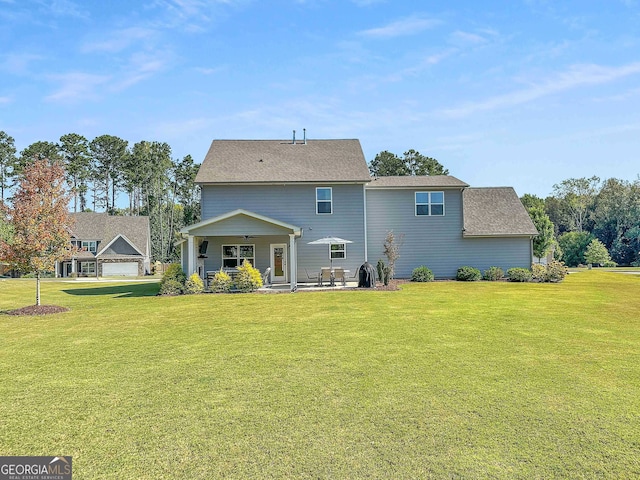 back of house with a yard and a patio area