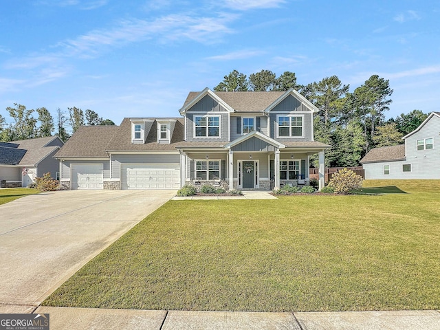 view of front facade featuring covered porch, a garage, and a front lawn