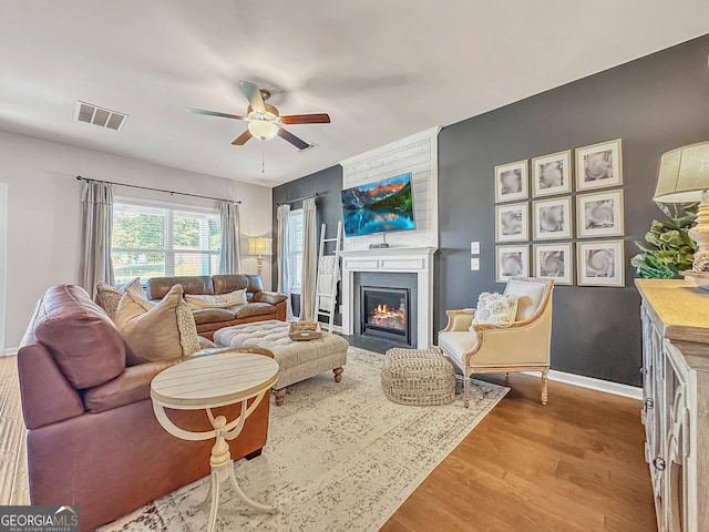 living room with wood-type flooring and ceiling fan