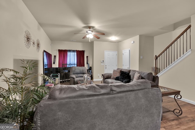 living room featuring hardwood / wood-style floors and ceiling fan