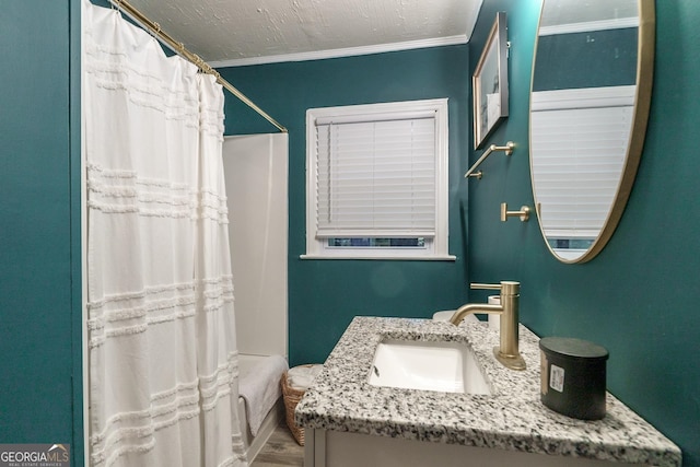 bathroom with hardwood / wood-style floors, crown molding, vanity, a textured ceiling, and a shower with shower curtain