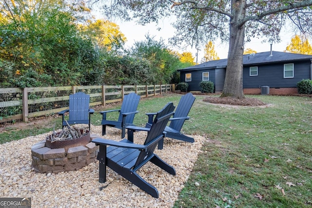 view of yard featuring cooling unit and an outdoor fire pit