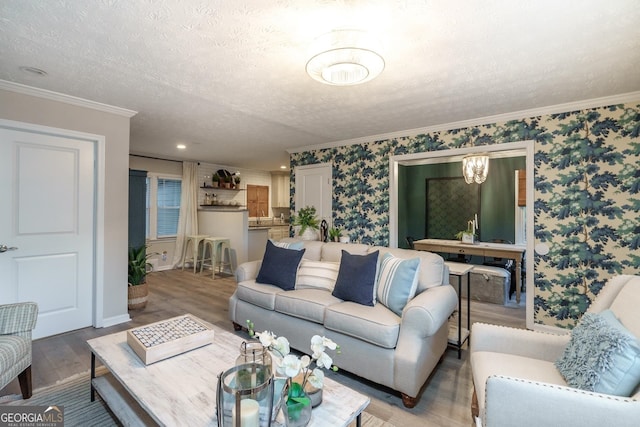 living room featuring ornamental molding, a textured ceiling, and hardwood / wood-style flooring