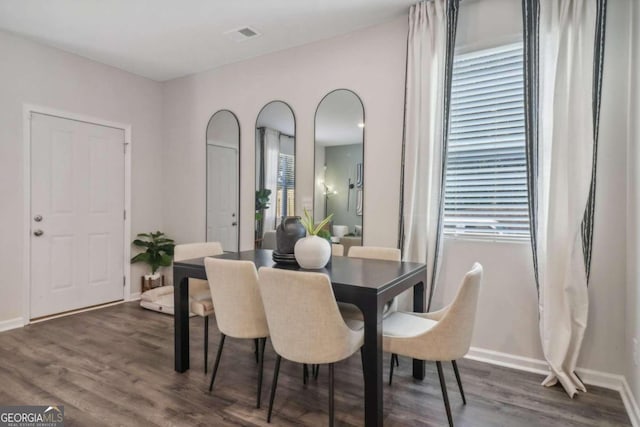 dining space with dark hardwood / wood-style flooring