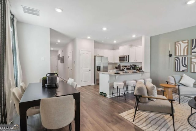 dining area featuring hardwood / wood-style floors