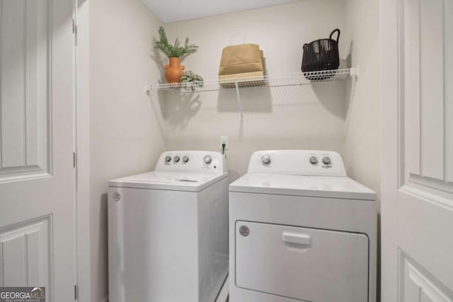 laundry room with washing machine and clothes dryer