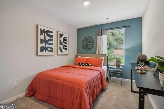 bedroom featuring light colored carpet