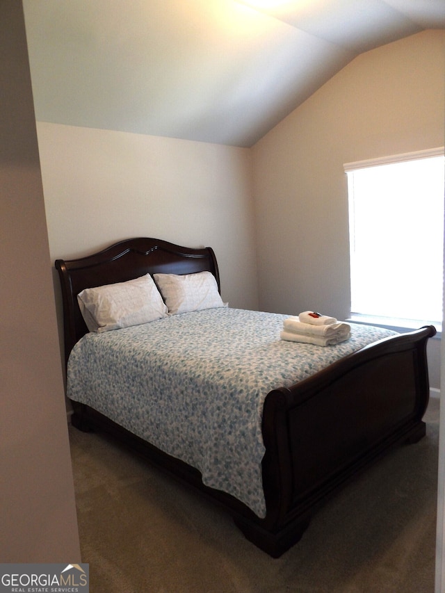 carpeted bedroom featuring vaulted ceiling