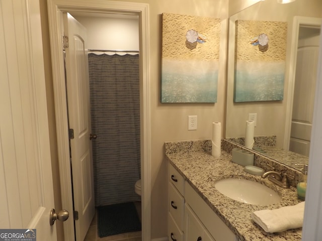 bathroom with vanity, toilet, and walk in shower