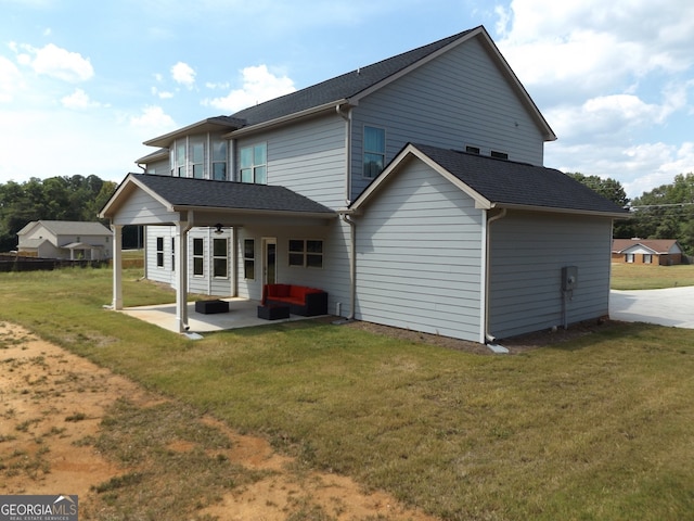 rear view of property with a patio area and a lawn