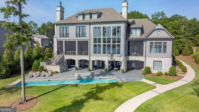 back of property with a lawn, a patio, and a sunroom