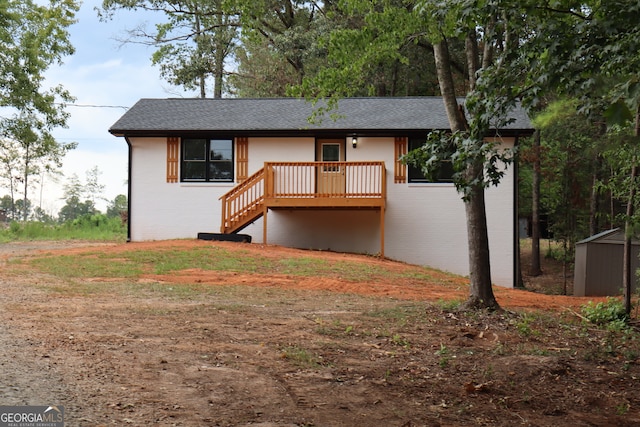 view of front of house featuring a storage unit