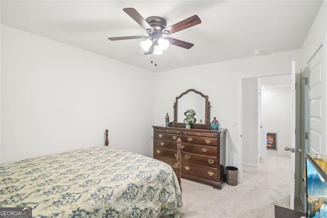 bedroom with ceiling fan and light colored carpet