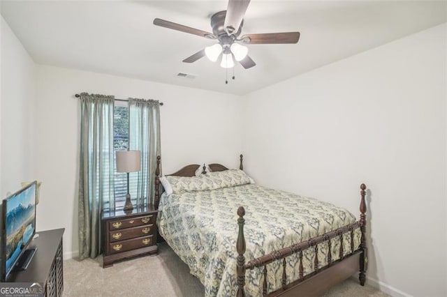 bedroom featuring a ceiling fan, light colored carpet, visible vents, and baseboards