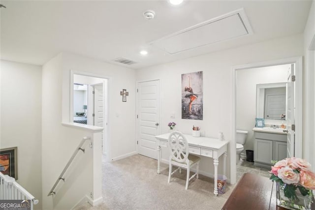 home office featuring light carpet, visible vents, attic access, and baseboards