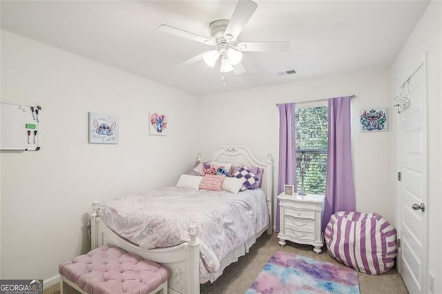 bedroom with carpet floors, visible vents, and ceiling fan