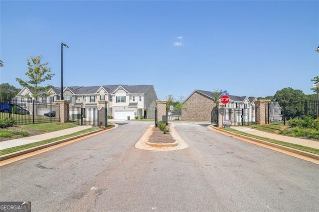 view of road featuring curbs, traffic signs, sidewalks, and a residential view