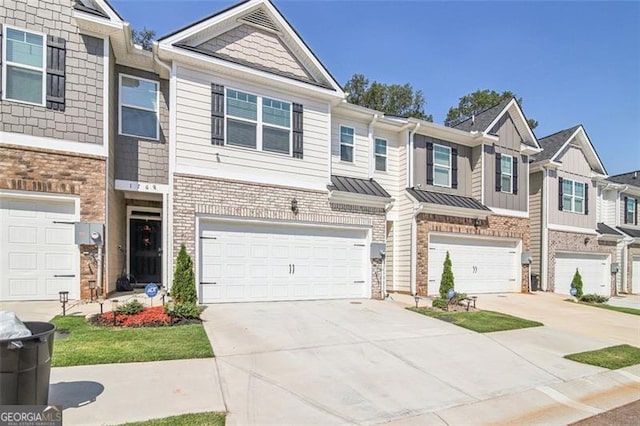 multi unit property featuring a garage, concrete driveway, brick siding, and a standing seam roof