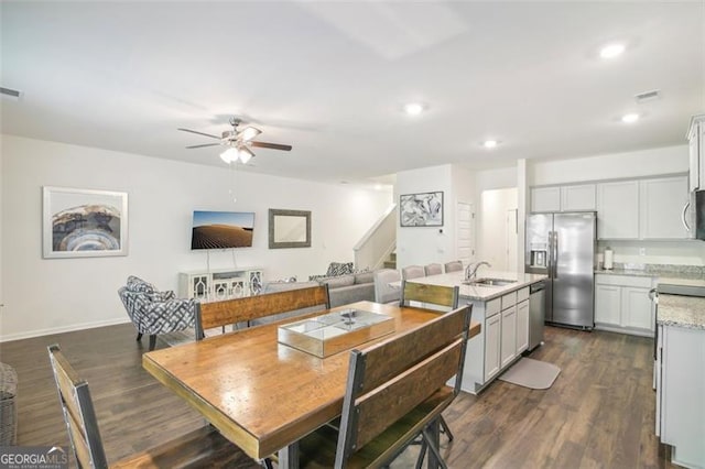 dining space featuring dark wood-style floors, recessed lighting, ceiling fan, and stairway