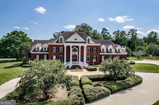 greek revival house featuring a front lawn