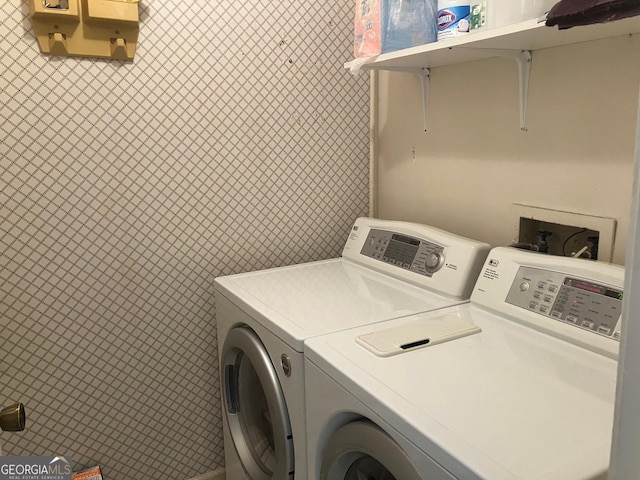 laundry room with tile walls and washing machine and dryer