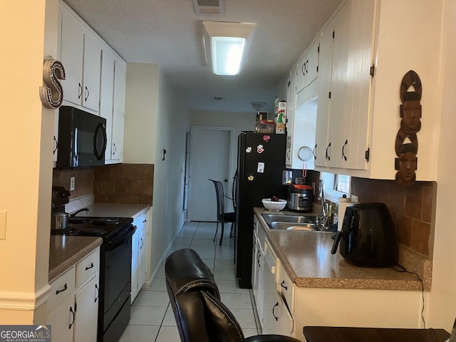 kitchen with a textured ceiling, black appliances, tasteful backsplash, white cabinets, and light tile patterned flooring