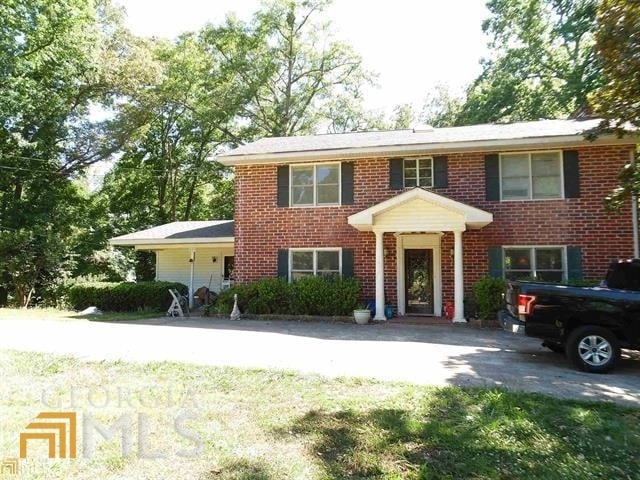 573 Lester Rd, Fayetteville, GA 30215 - colonial home featuring brick siding