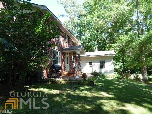 573 Lester Rd, Fayetteville, GA 30215 - rear view of house featuring a yard