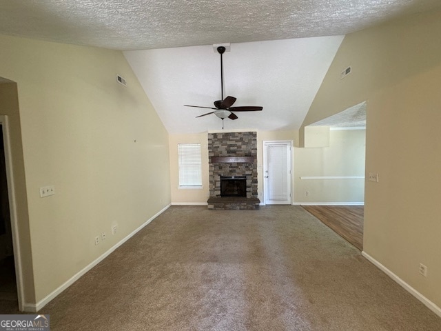 unfurnished living room featuring a fireplace, a textured ceiling, ceiling fan, and lofted ceiling