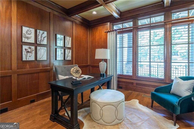 office area with coffered ceiling, hardwood / wood-style floors, and wooden walls