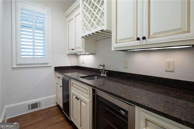 kitchen with dishwasher, dark hardwood / wood-style flooring, sink, dark stone counters, and wine cooler