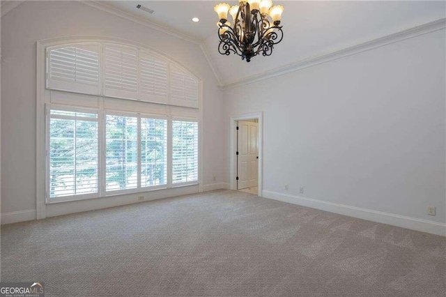 carpeted empty room featuring crown molding, vaulted ceiling, and an inviting chandelier