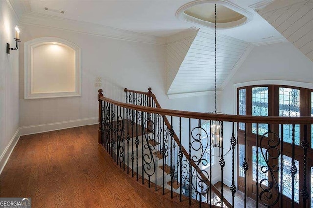 hallway featuring ornamental molding, a chandelier, french doors, dark hardwood / wood-style floors, and vaulted ceiling