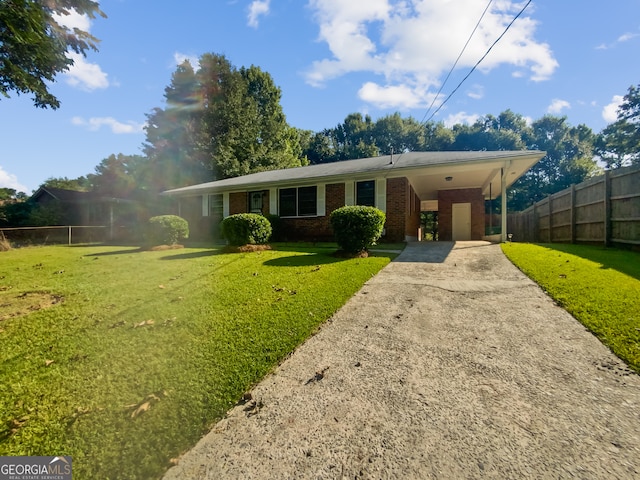 single story home with a front yard and a carport