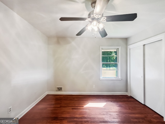 unfurnished bedroom featuring a closet, ceiling fan, and dark hardwood / wood-style floors