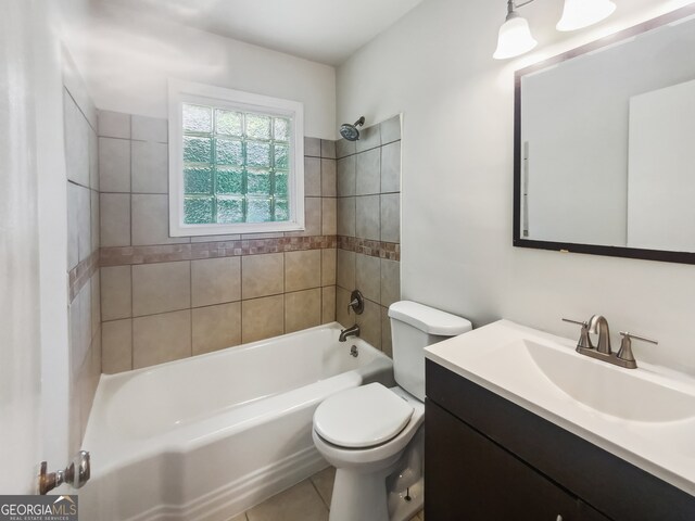 full bathroom with tile patterned flooring, toilet, tiled shower / bath combo, and vanity