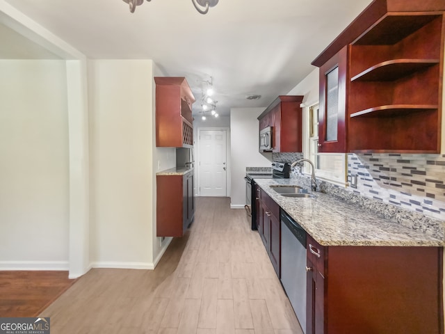 kitchen featuring light hardwood / wood-style flooring, stainless steel appliances, sink, and backsplash