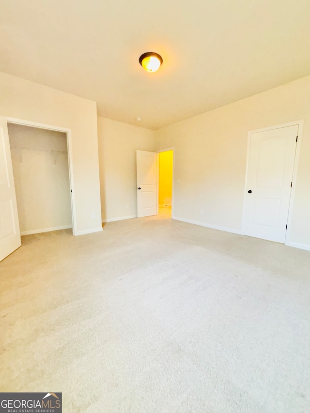 unfurnished bedroom with a closet and carpet