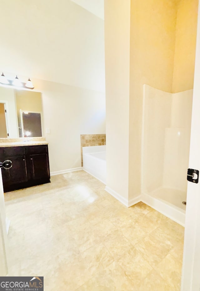 bathroom featuring vanity and shower with separate bathtub