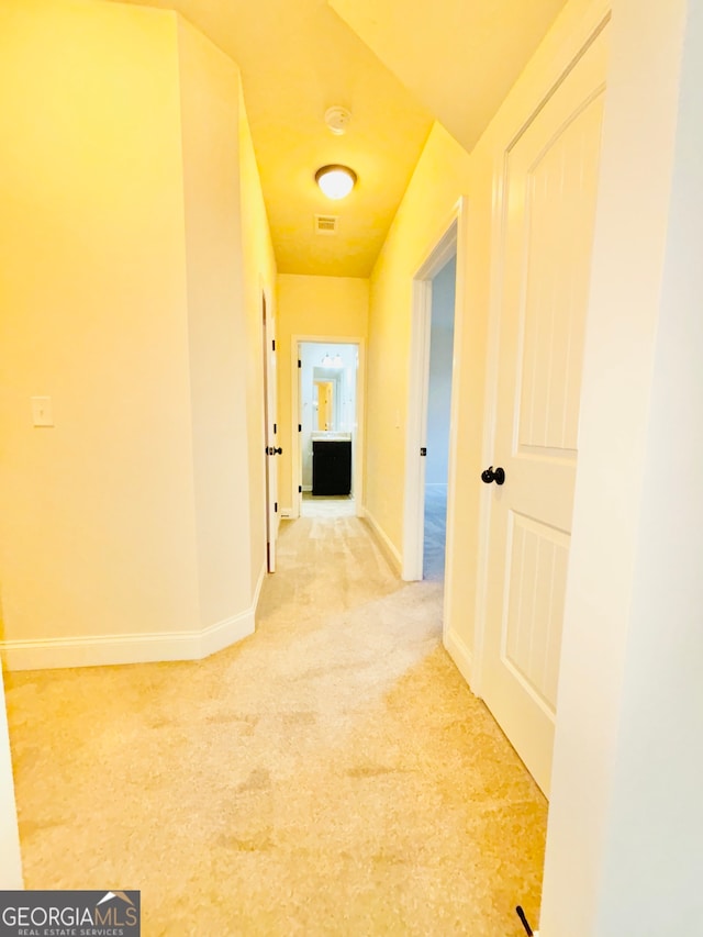 hallway with carpet floors