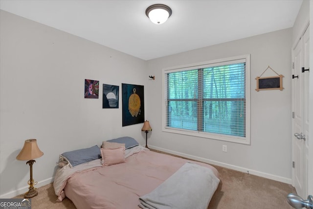 bedroom featuring light colored carpet