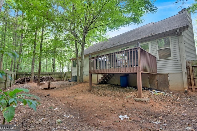 back of property featuring central AC unit and a deck