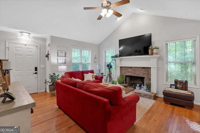 living room featuring a fireplace, high vaulted ceiling, hardwood / wood-style flooring, and ceiling fan