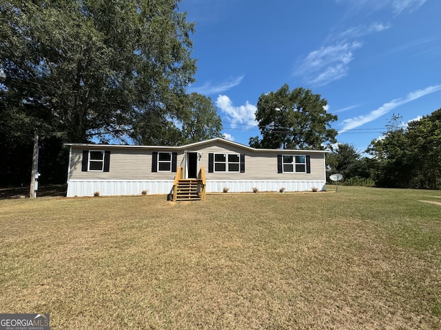 manufactured / mobile home featuring a front lawn