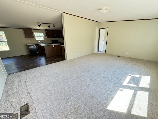 unfurnished living room featuring wood-type flooring and a textured ceiling