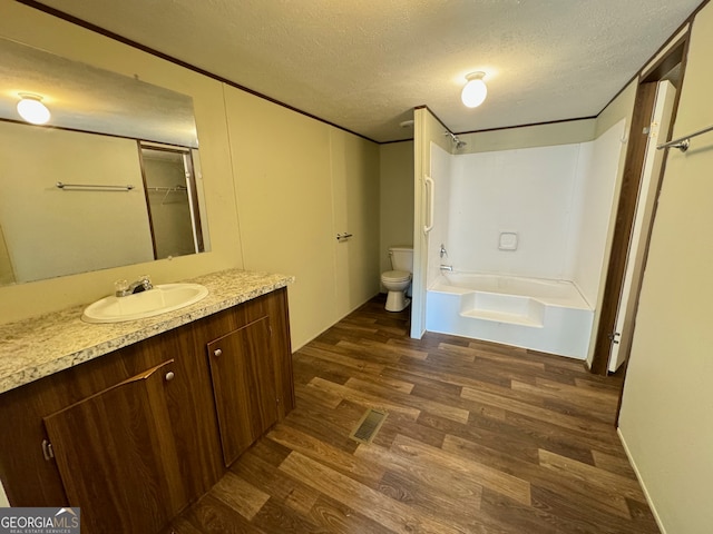 full bathroom featuring vanity, toilet, shower / washtub combination, and hardwood / wood-style flooring