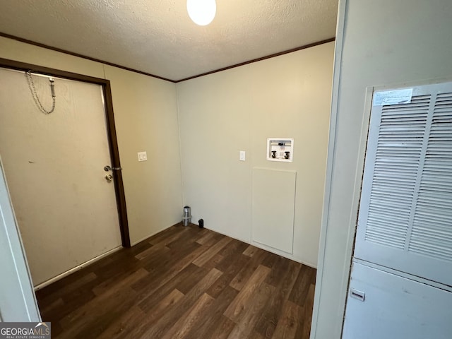 laundry area with washer hookup, a textured ceiling, ornamental molding, and dark hardwood / wood-style floors