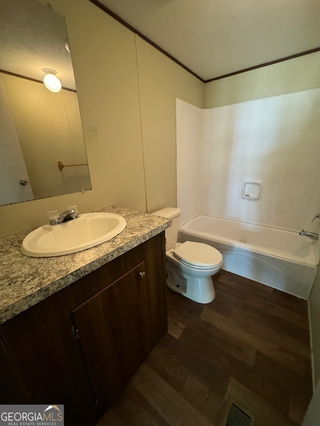 full bathroom featuring vanity, toilet, hardwood / wood-style floors, and  shower combination