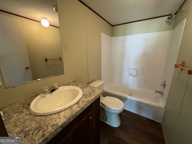 full bathroom with shower / tub combination, hardwood / wood-style floors, toilet, and vanity